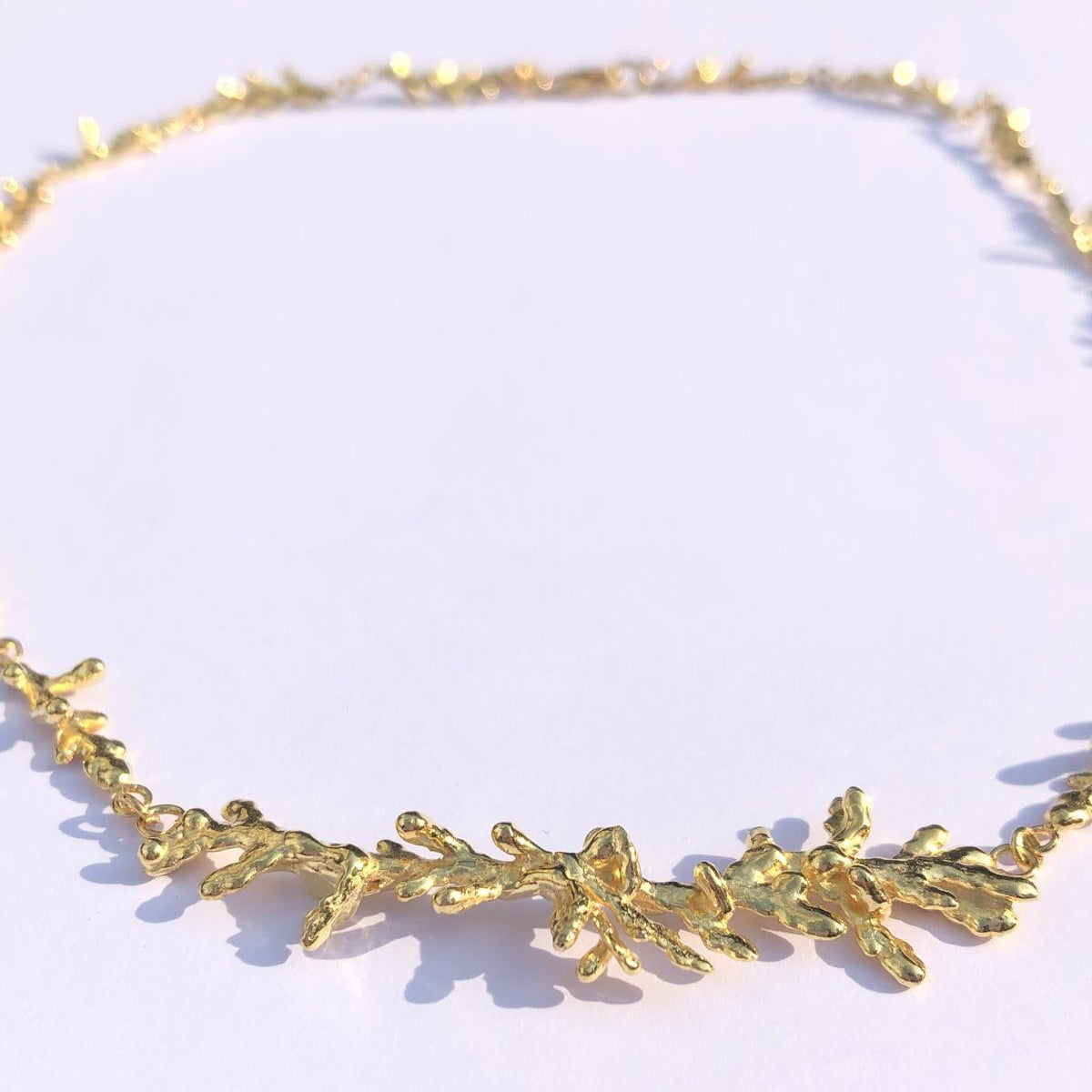 A stunning, nature-inspired statement necklace crafted from authentic 925 sterling silver with a rich gold finish, perfect for a unique botanical or bohemian style.