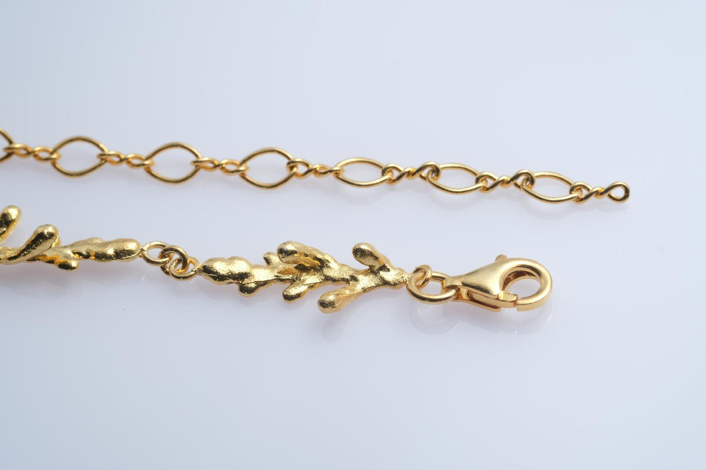 Front view of the continuous pine branch and twig links, creating an elegant piece of woodland-inspired jewelry symbolizing resilience.