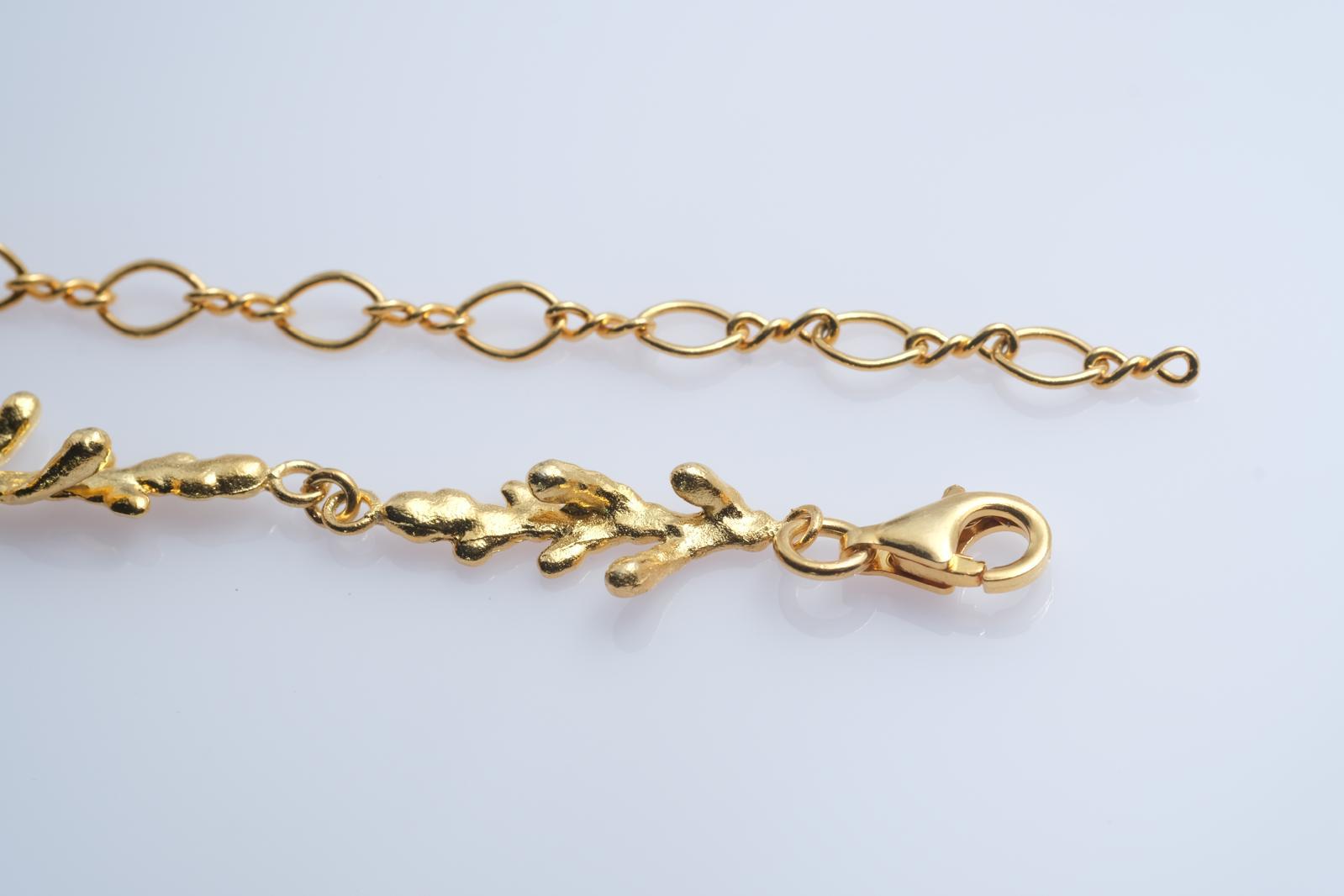 Front view of the continuous pine branch and twig links, creating an elegant piece of woodland-inspired jewelry symbolizing resilience.