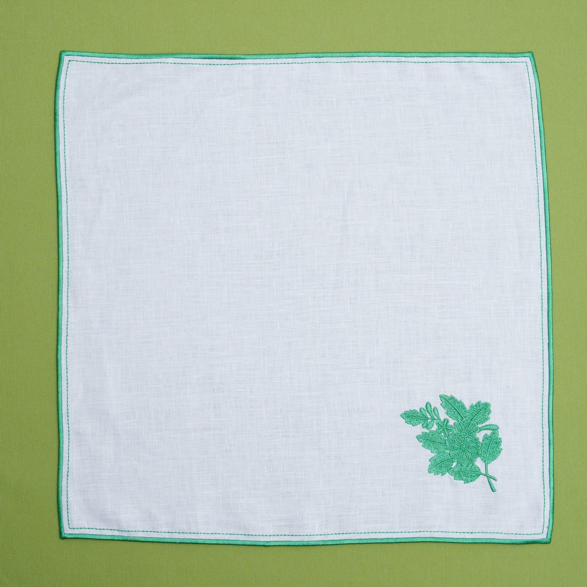 Soft linen placemat with stitched leaf motif arranged for fine dining