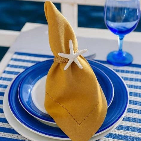 Front view of coastal chic white starfish napkin ring for beach theme table decor.