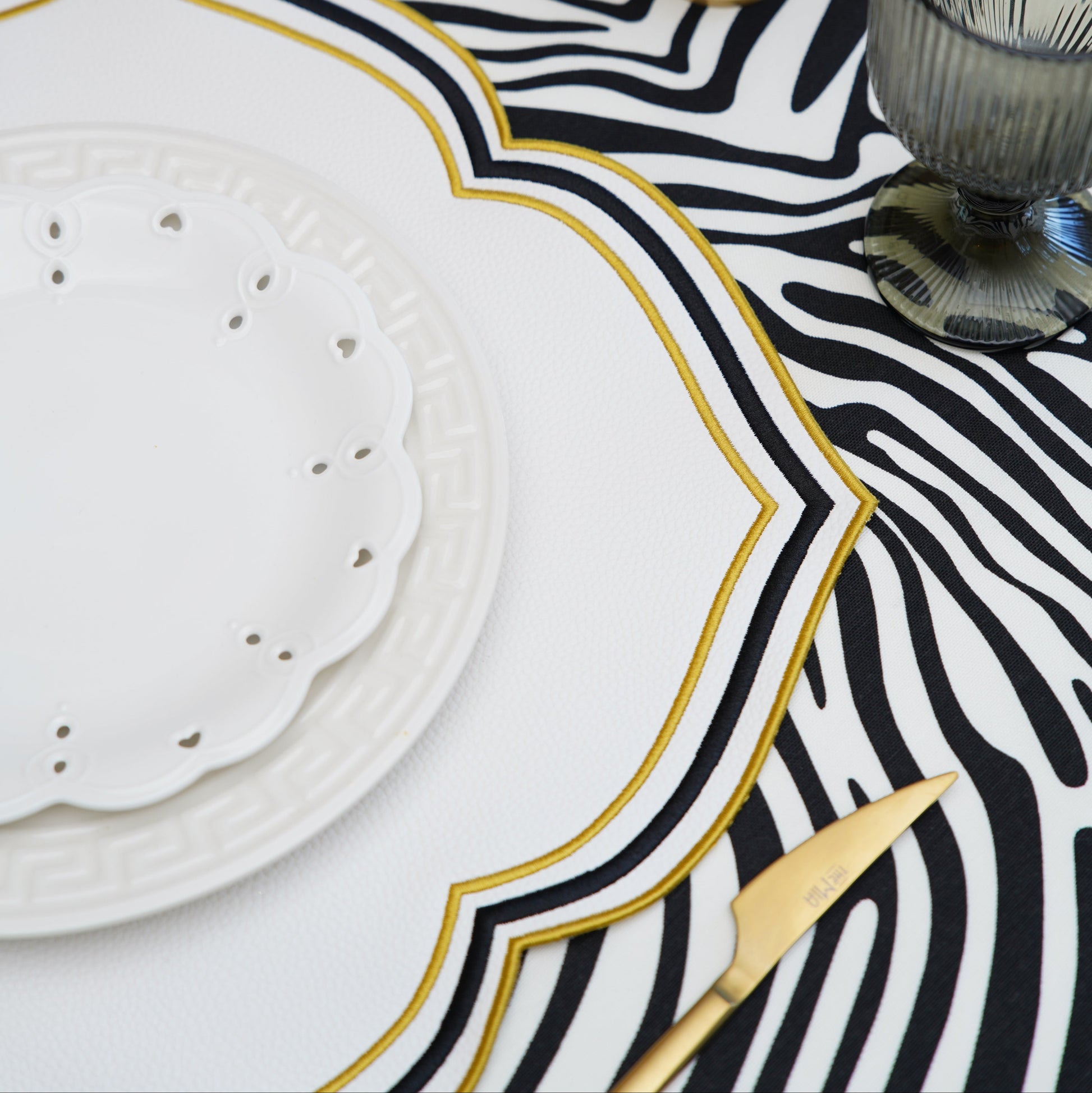 Zeal's premium faux leather placemat features a refined square shape with sophisticated stitched trim, ideal for upscale dining decor.